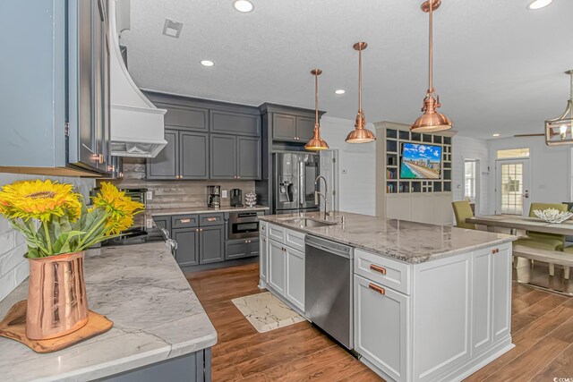 4600 Murrells Inlet Rd, Murrells Inlet, SC 29576 - kitchen with stainless steel appliances, wall chimney exhaust hood, tasteful backsplash, recessed lighting, and wood finished floors