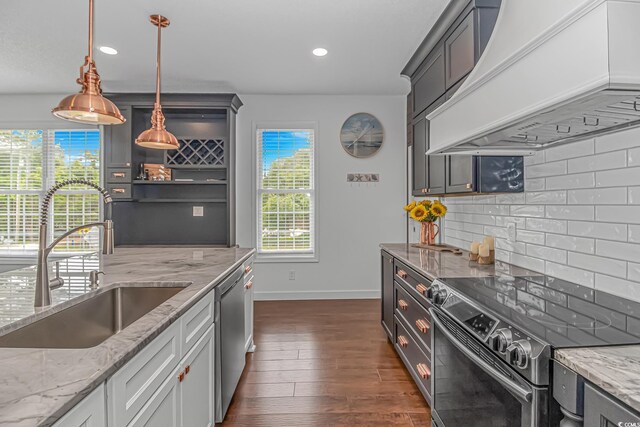 4600 Murrells Inlet Rd, Murrells Inlet, SC 29576 - kitchen featuring appliances with stainless steel finishes, custom exhaust hood, decorative backsplash, recessed lighting, and light stone countertops