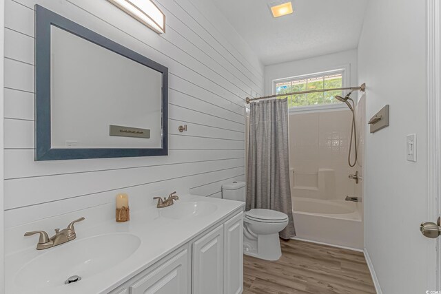 4600 Murrells Inlet Rd, Murrells Inlet, SC 29576 - bathroom featuring double vanity, shower / bath combo with shower curtain, wood finished floors, and wooden walls