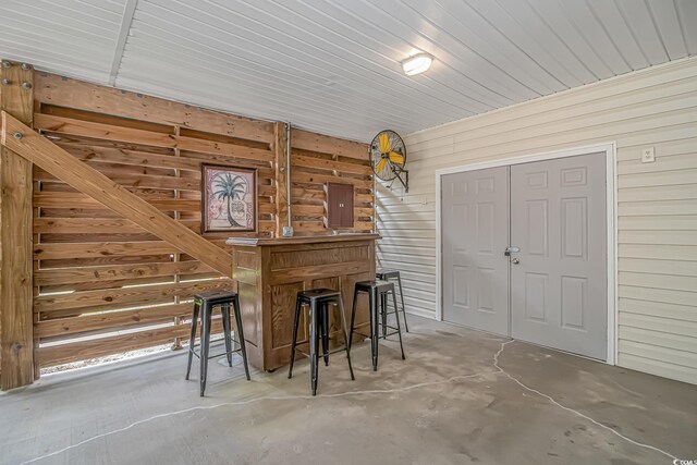 4600 Murrells Inlet Rd, Murrells Inlet, SC 29576 - bar area featuring wooden walls, electric panel, and concrete floors