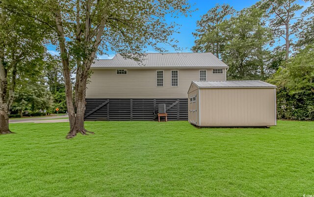 4600 Murrells Inlet Rd, Murrells Inlet, SC 29576 - back of house with a yard, a storage unit, and a metal roof