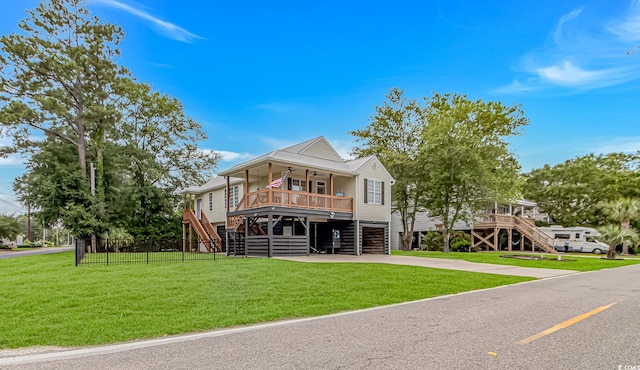 4600 Murrells Inlet Rd, Murrells Inlet, SC 29576 - coastal inspired home featuring stairs, a ceiling fan, covered porch, concrete driveway, and an attached garage
