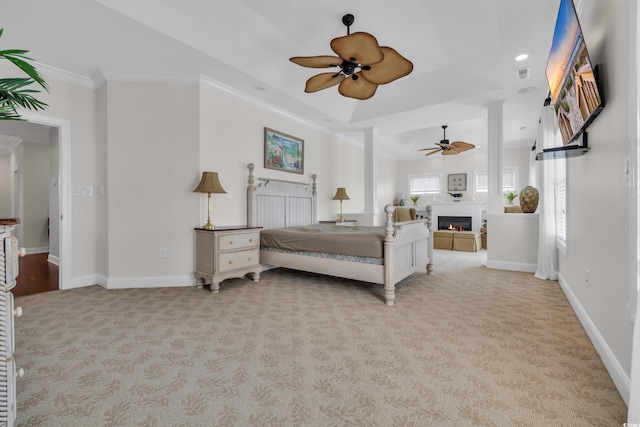 1619 Eastover Ln, North Myrtle Beach, SC 29582 - bedroom featuring light carpet, ornamental molding, a tray ceiling, a glass covered fireplace, and baseboards