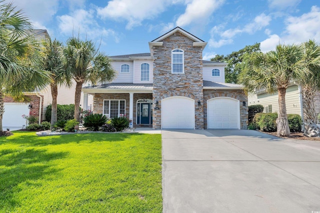 1619 Eastover Ln, North Myrtle Beach, SC 29582 - view of front of home featuring driveway, a front yard, an attached garage, a standing seam roof, and stone siding