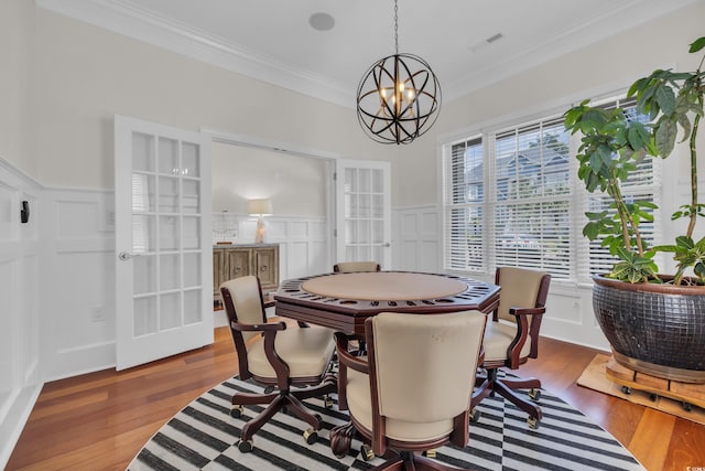 1619 Eastover Ln, North Myrtle Beach, SC 29582 - dining room with a decorative wall, ornamental molding, a chandelier, wood finished floors, and a desk