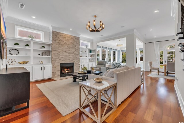 1619 Eastover Ln, North Myrtle Beach, SC 29582 - living area with crown molding, a chandelier, a fireplace, wood-type flooring, and recessed lighting