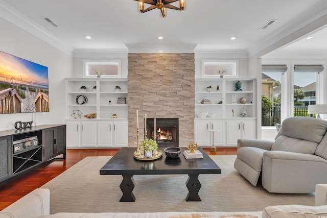 1619 Eastover Ln, North Myrtle Beach, SC 29582 - living area with crown molding, wood finished floors, a stone fireplace, built in shelves, and recessed lighting