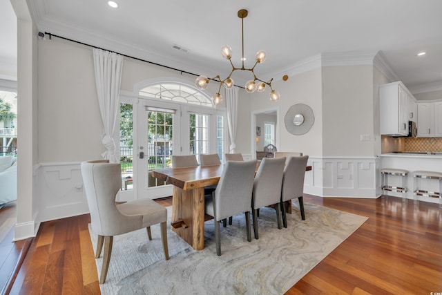 1619 Eastover Ln, North Myrtle Beach, SC 29582 - dining area with crown molding, a wainscoted wall, a chandelier, wood finished floors, and recessed lighting