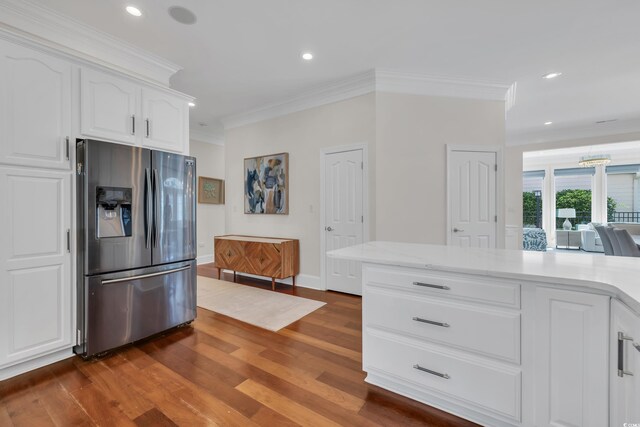 1619 Eastover Ln, North Myrtle Beach, SC 29582 - kitchen with stainless steel fridge with ice dispenser, ornamental molding, dark wood finished floors, white cabinetry, and recessed lighting
