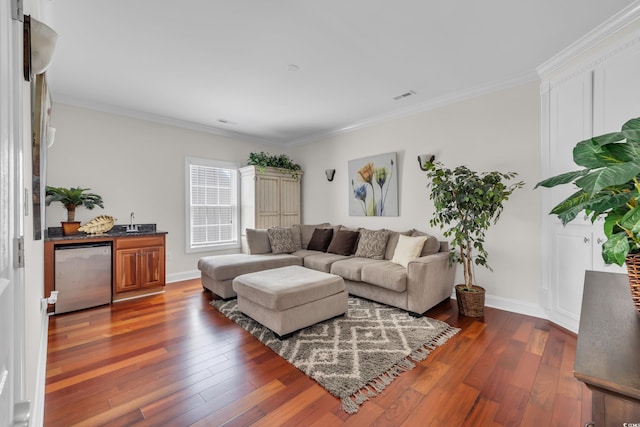 1619 Eastover Ln, North Myrtle Beach, SC 29582 - living area with crown molding, dark wood finished floors, baseboards, and bar area