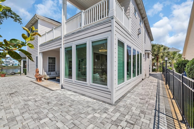 1619 Eastover Ln, North Myrtle Beach, SC 29582 - view of side of property with a balcony, a fenced backyard, and a patio area