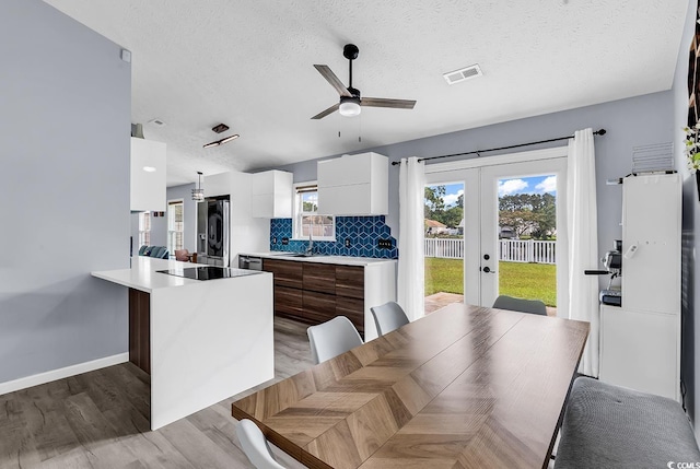 5031 Medieval Dr, Conway, SC 29526 - kitchen with modern cabinets, refrigerator with ice dispenser, white cabinets, french doors, and light wood-type flooring