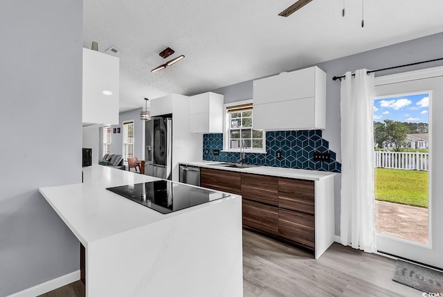 5031 Medieval Dr, Conway, SC 29526 - kitchen featuring modern cabinets, appliances with stainless steel finishes, white cabinets, light countertops, and light wood finished floors