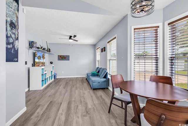 5031 Medieval Dr, Conway, SC 29526 - dining room featuring light wood-type flooring, a textured ceiling, a ceiling fan, baseboards, and a chandelier