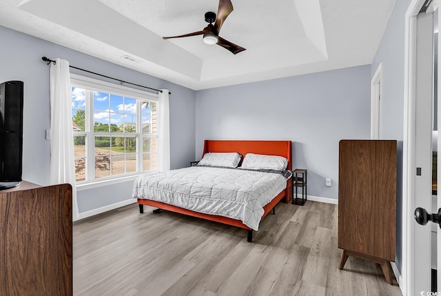 5031 Medieval Dr, Conway, SC 29526 - bedroom with a raised ceiling, wood finished floors, baseboards, and a ceiling fan