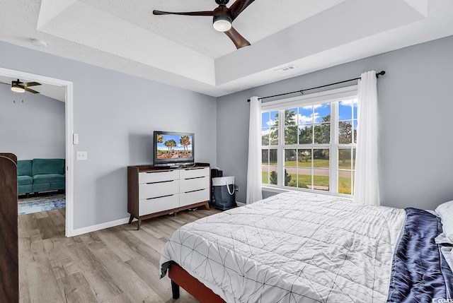 5031 Medieval Dr, Conway, SC 29526 - bedroom with a raised ceiling, wood finished floors, baseboards, and a ceiling fan