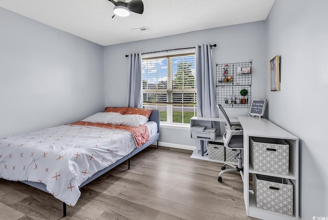 5031 Medieval Dr, Conway, SC 29526 - bedroom with wood finished floors, baseboards, and a ceiling fan
