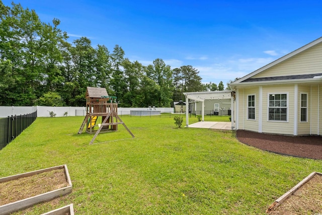 104 Browns Hollow Ct, Loris, SC 29569 - fenced backyard featuring a playground, a patio, and a garden