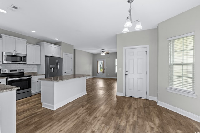 104 Browns Hollow Ct, Loris, SC 29569 - kitchen featuring stainless steel appliances, dark wood-type flooring, white cabinetry, backsplash, and recessed lighting