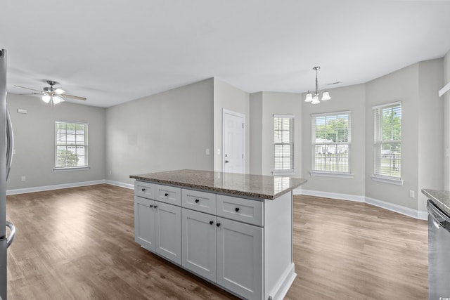 104 Browns Hollow Ct, Loris, SC 29569 - kitchen featuring open floor plan, wood finished floors, a chandelier, and dishwasher