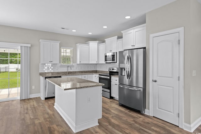 104 Browns Hollow Ct, Loris, SC 29569 - kitchen with appliances with stainless steel finishes, tasteful backsplash, a center island, white cabinets, and recessed lighting