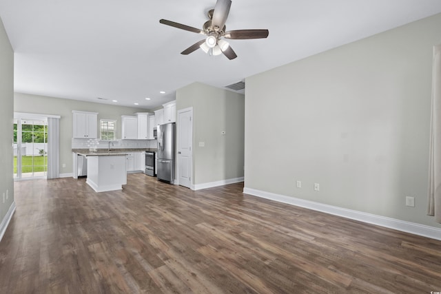 104 Browns Hollow Ct, Loris, SC 29569 - unfurnished living room with dark wood-type flooring, ceiling fan, and recessed lighting