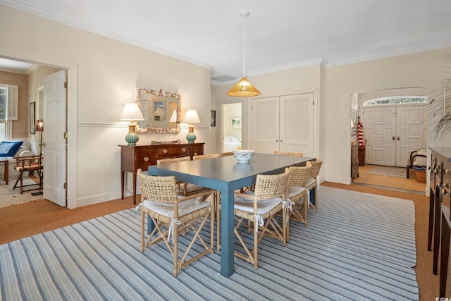 95 Sanderling Ave, Georgetown, SC 29440 - dining space featuring crown molding, light colored carpet, arched walkways, and baseboards