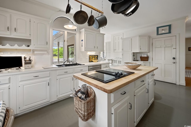 95 Sanderling Ave, Georgetown, SC 29440 - kitchen featuring butcher block counters, black electric cooktop, a sink, white cabinetry, and a center island