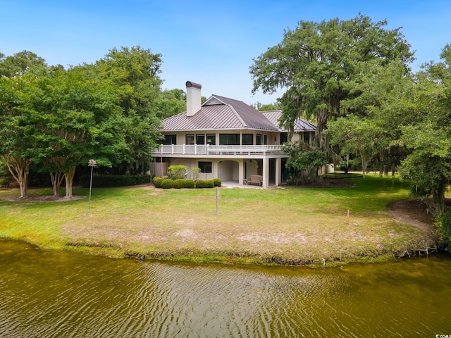 95 Sanderling Ave, Georgetown, SC 29440 - rear view of property featuring a chimney, a lawn, metal roof, and a standing seam roof
