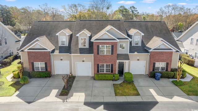 4378 Willoughby Ln Unit 4378, Myrtle Beach, SC 29577 - view of front of house featuring a garage, driveway, brick siding, and a shingled roof