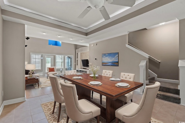 4378 Willoughby Ln Unit 4378, Myrtle Beach, SC 29577 - dining room featuring light tile patterned floors, a ceiling fan, stairs, ornamental molding, and a raised ceiling