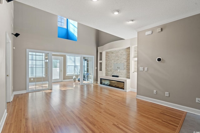 4378 Willoughby Ln Unit 4378, Myrtle Beach, SC 29577 - unfurnished living room with a glass covered fireplace, healthy amount of natural light, wood finished floors, and a textured ceiling