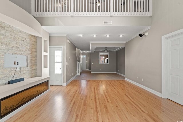 4378 Willoughby Ln Unit 4378, Myrtle Beach, SC 29577 - unfurnished living room with ornamental molding, a ceiling fan, light wood finished floors, and a high ceiling