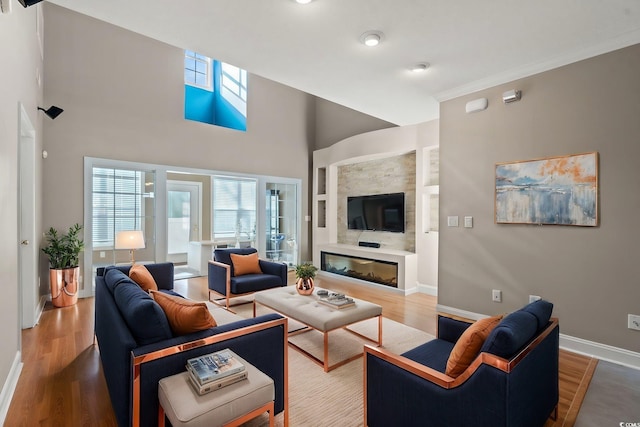 4378 Willoughby Ln Unit 4378, Myrtle Beach, SC 29577 - living area with wood finished floors, built in shelves, a glass covered fireplace, and a towering ceiling