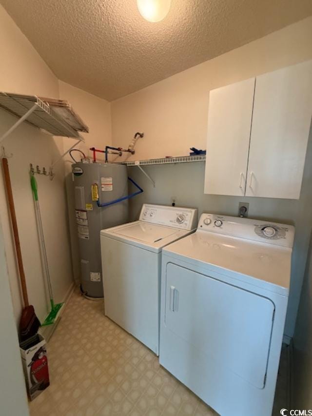 1980 Bent Grass Dr Unit F, Surfside Beach, SC 29575 - laundry room featuring electric water heater, cabinet space, light floors, washing machine and clothes dryer, and a textured ceiling