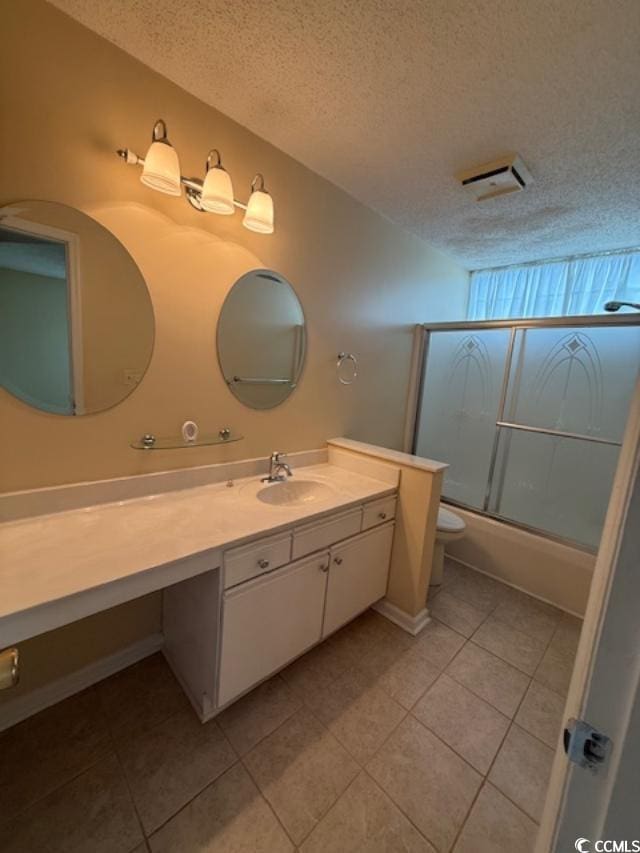 1980 Bent Grass Dr Unit F, Surfside Beach, SC 29575 - bathroom with tile patterned flooring, vanity, combined bath / shower with glass door, and a textured ceiling