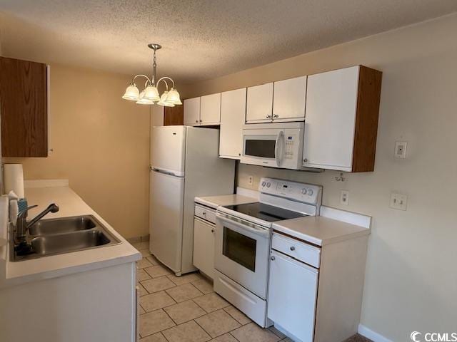 1980 Bent Grass Dr Unit F, Surfside Beach, SC 29575 - kitchen with white appliances, light countertops, white cabinets, a textured ceiling, and a chandelier