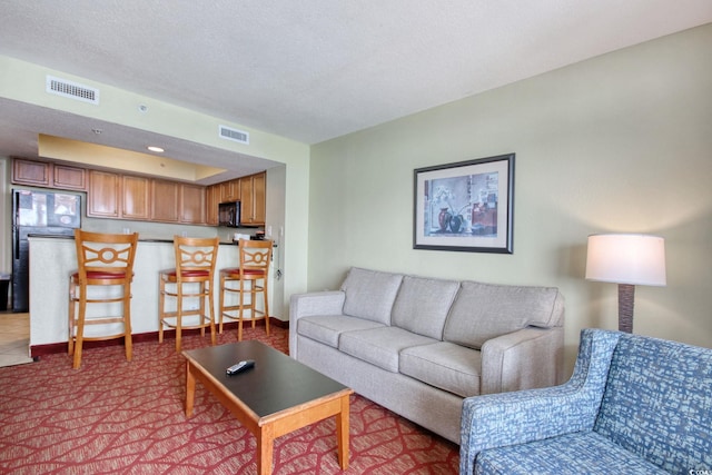 504 N Ocean Blvd Unit 1106, Myrtle Beach, SC 29577 - carpeted living area with a textured ceiling