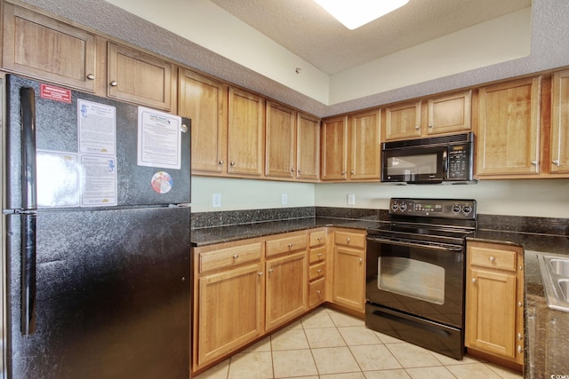 504 N Ocean Blvd Unit 1106, Myrtle Beach, SC 29577 - kitchen featuring black appliances, light tile patterned flooring, dark stone counters, and a textured ceiling