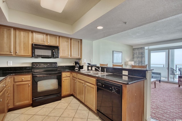 504 N Ocean Blvd Unit 1106, Myrtle Beach, SC 29577 - kitchen featuring black appliances, a peninsula, a textured ceiling, a sink, and dark stone countertops