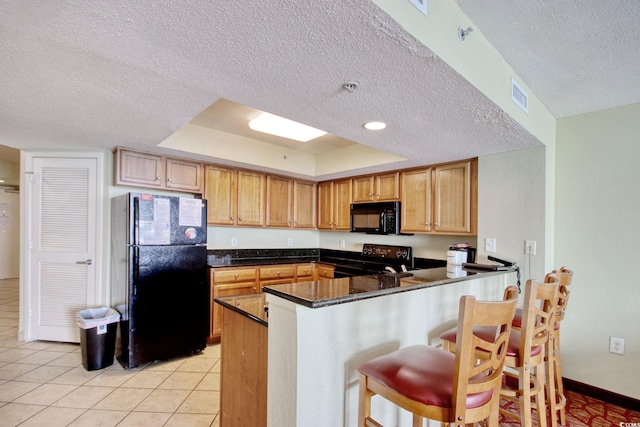 504 N Ocean Blvd Unit 1106, Myrtle Beach, SC 29577 - kitchen with black appliances, a textured ceiling, a peninsula, dark countertops, and light tile patterned flooring