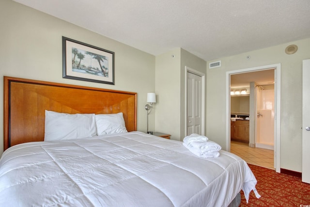 504 N Ocean Blvd Unit 1106, Myrtle Beach, SC 29577 - tiled bedroom featuring a closet, connected bathroom, and baseboards