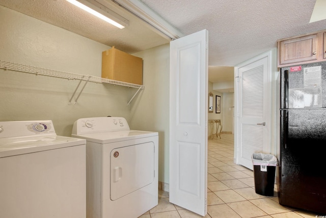 504 N Ocean Blvd Unit 1106, Myrtle Beach, SC 29577 - laundry area with washer and dryer, light tile patterned floors, and a textured ceiling