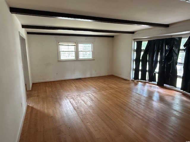 4909 Yaupon Cir, Myrtle Beach, SC 29575 - empty room with plenty of natural light, wood finished floors, beam ceiling, and baseboards