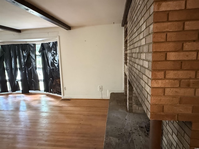 4909 Yaupon Cir, Myrtle Beach, SC 29575 - foyer entrance featuring beamed ceiling, wood finished floors, brick wall, and baseboards