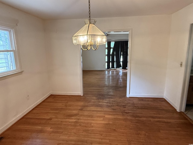4909 Yaupon Cir, Myrtle Beach, SC 29575 - unfurnished dining area featuring a chandelier, wood finished floors, and baseboards