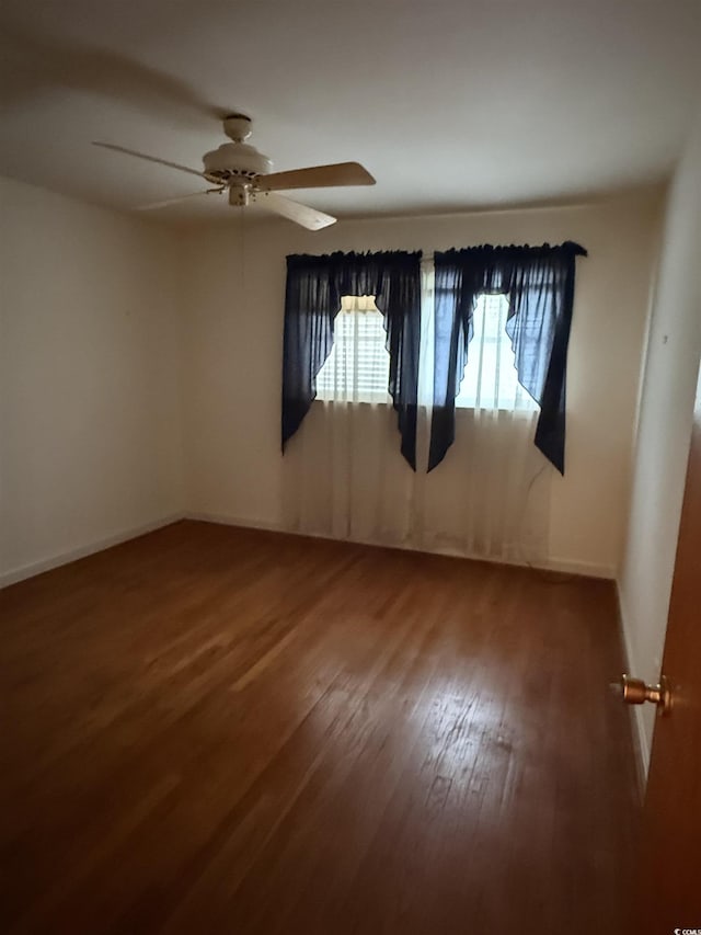 4909 Yaupon Cir, Myrtle Beach, SC 29575 - spare room with wood finished floors, a ceiling fan, and baseboards