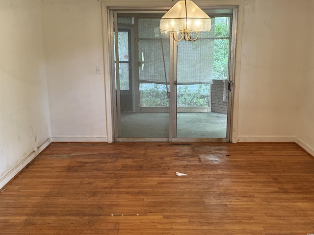 4909 Yaupon Cir, Myrtle Beach, SC 29575 - unfurnished dining area featuring a chandelier, wood finished floors, and baseboards