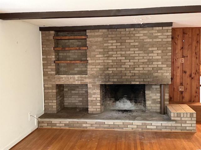 4909 Yaupon Cir, Myrtle Beach, SC 29575 - detailed view of wood finished floors, a brick fireplace, baseboards, and beam ceiling