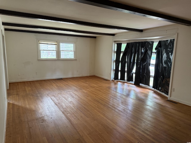 4909 Yaupon Cir, Myrtle Beach, SC 29575 - unfurnished room with beam ceiling, wood-type flooring, baseboards, and healthy amount of natural light